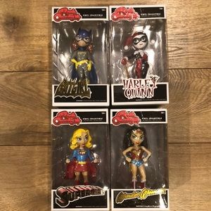 Vinyl collectibles:Batgirl, Harley Quinn, Supergirl and Wonder Woman.